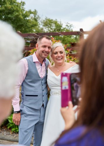 Wedding couple posing at reception for family 